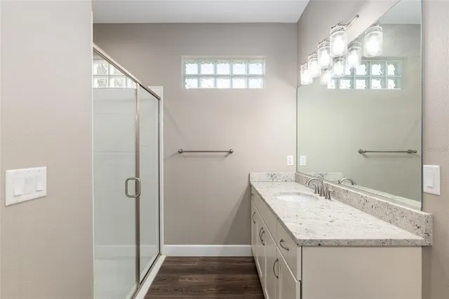 a bathroom with a double vanity sink and a mirror