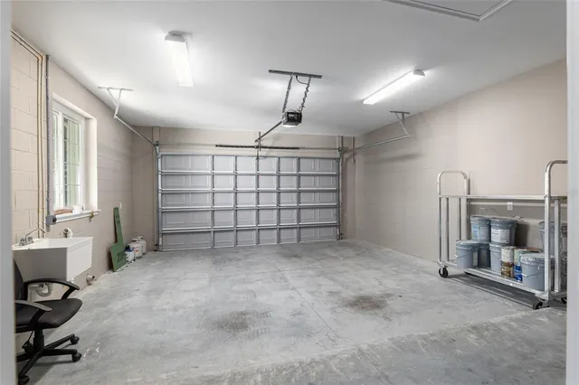 a kitchen with granite countertop a sink a stove and cabinets