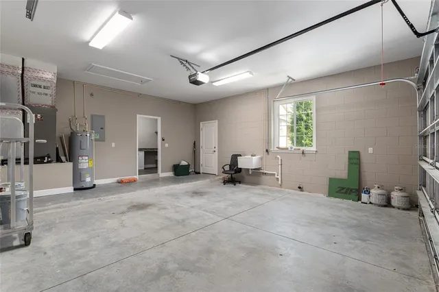 a view of a kitchen with a sink and dishwasher a stove top oven with wooden floor