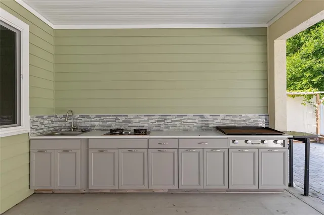 a view of a backyard with plants and a chair