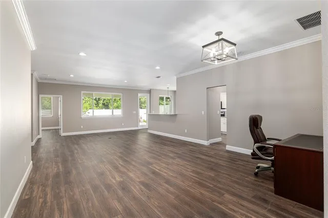 a view of a workspace with wooden floor