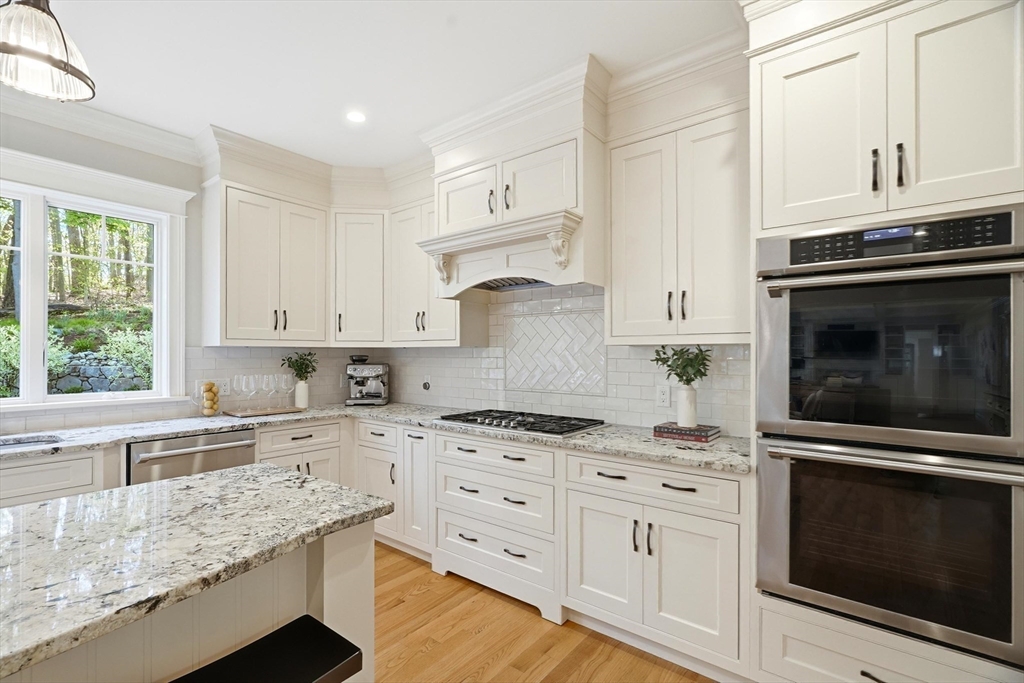 6 Flintlock Road Lexington, MA 02420 - Photo 11 of 39 a kitchen with stainless steel appliances granite countertop a stove a sink and a microwave