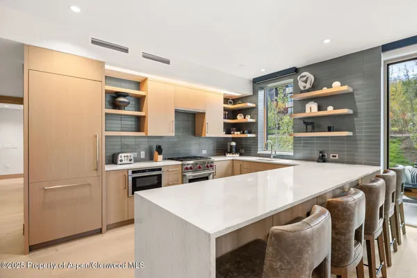 a bathroom with a shower curtain and chandelier