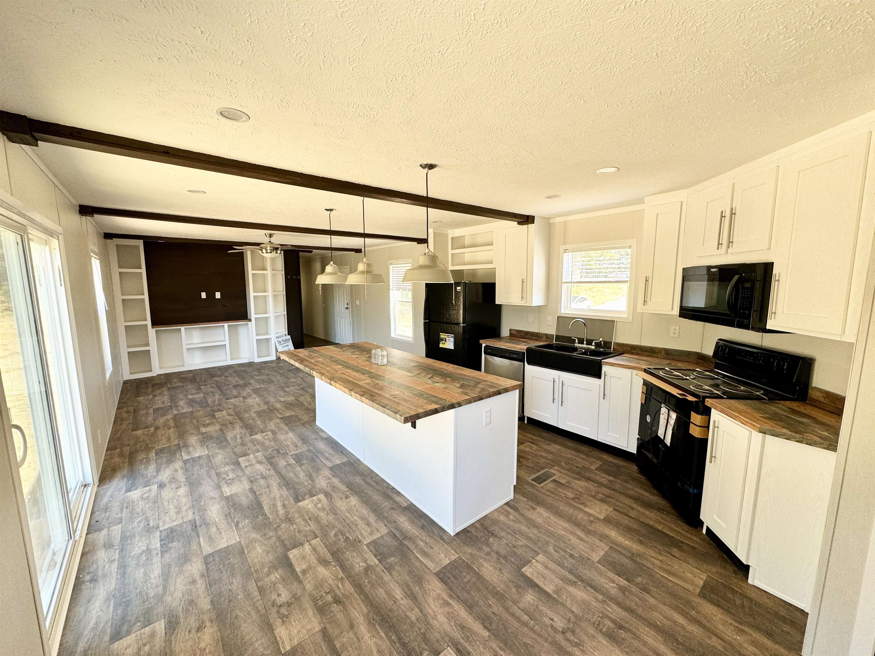 8340 Lightfoot Luckett Road Henning, TN 38041 - Photo 3 of 17 Kitchen with white cabinetry, black appliances, pendant lighting, and butcher block countertops
