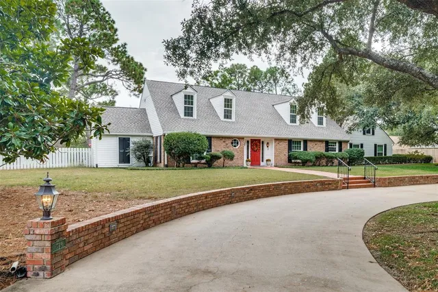 a view of a house with a yard and tree s