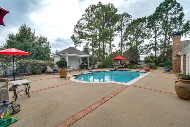 an outdoor space with swimming pool and furniture