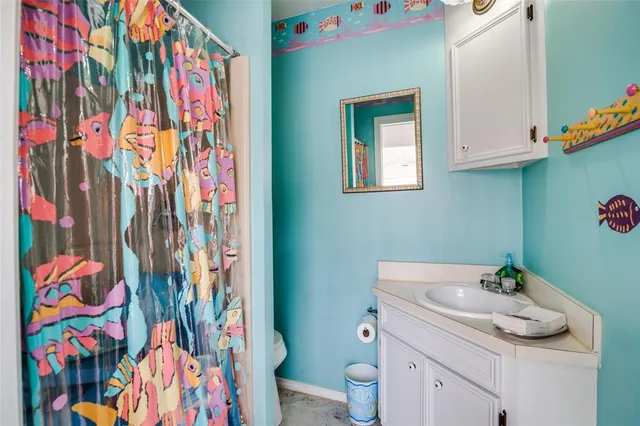 a bathroom with a sink toilet and vanity