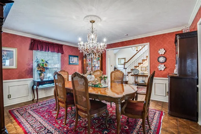 a view of a dining room with furniture a rug and wooden floor