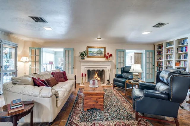 a living room with furniture fireplace and a large window