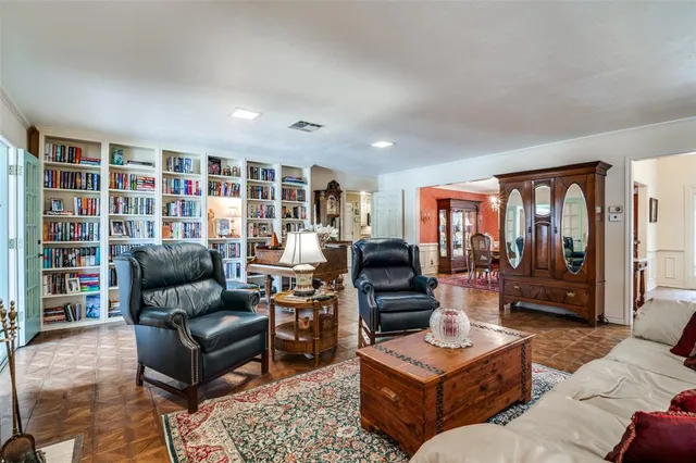 a living room with furniture and a bookshelf