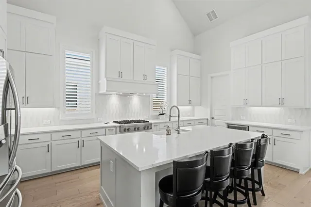 a kitchen with a sink stove and cabinets