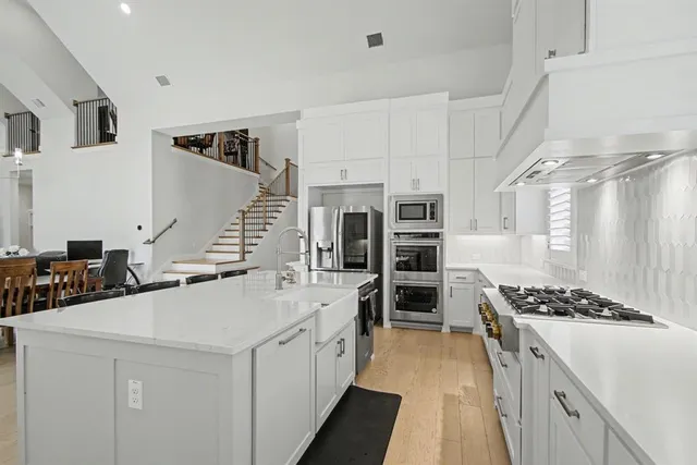 a kitchen with stainless steel appliances granite countertop a stove and a refrigerator