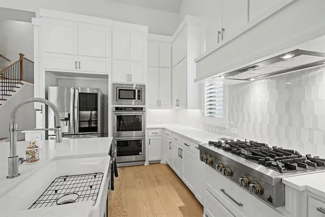 a kitchen with a sink stove and refrigerator