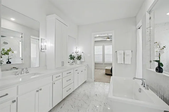 a bathroom with a tub sink and mirror
