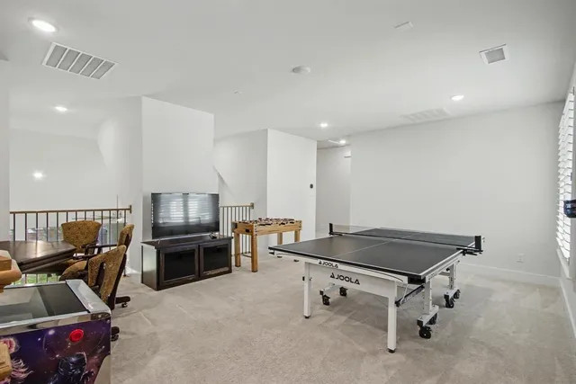 a room with furniture and air hockey table