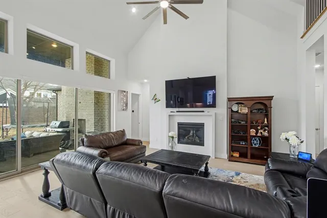 a living room with furniture and a view of kitchen