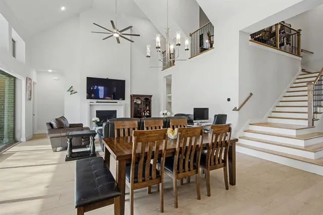 a large kitchen with kitchen island granite countertop a table chairs sink and cabinets