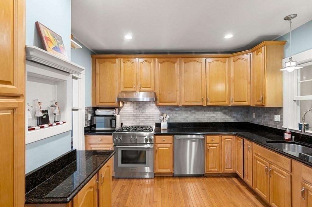 16 Manson Road Needham, MA 02494 - Photo 11 of 34 a kitchen with a stove a sink and a microwave