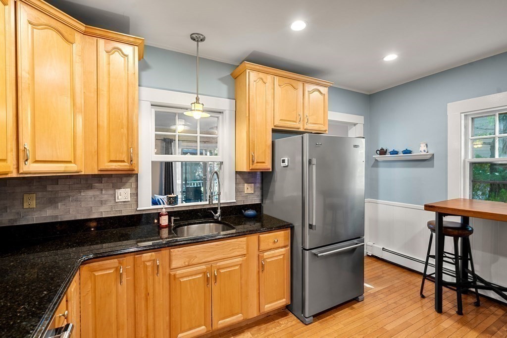 16 Manson Road Needham, MA 02494 - Photo 13 of 34 a kitchen with stainless steel appliances granite countertop a refrigerator a sink a stove and island