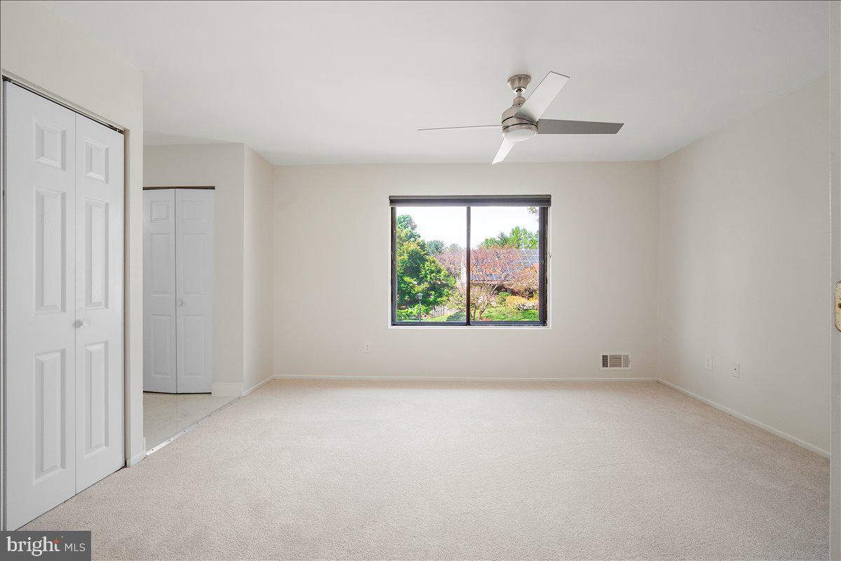 3912 Gelding Lane Olney, MD 20832 - Photo 12 of 62 an empty room with windows and chandelier fan