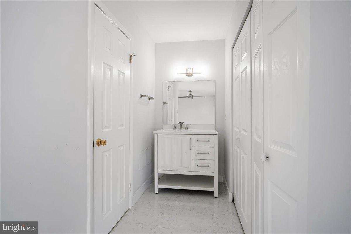3912 Gelding Lane Olney, MD 20832 - Photo 14 of 62 a bathroom with a sink a mirror and a shower