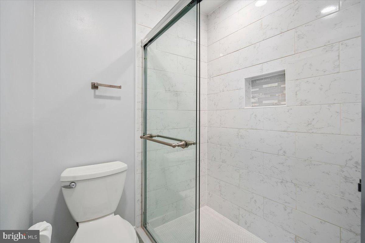 3912 Gelding Lane Olney, MD 20832 - Photo 15 of 62 a white toilet sitting next to a shower