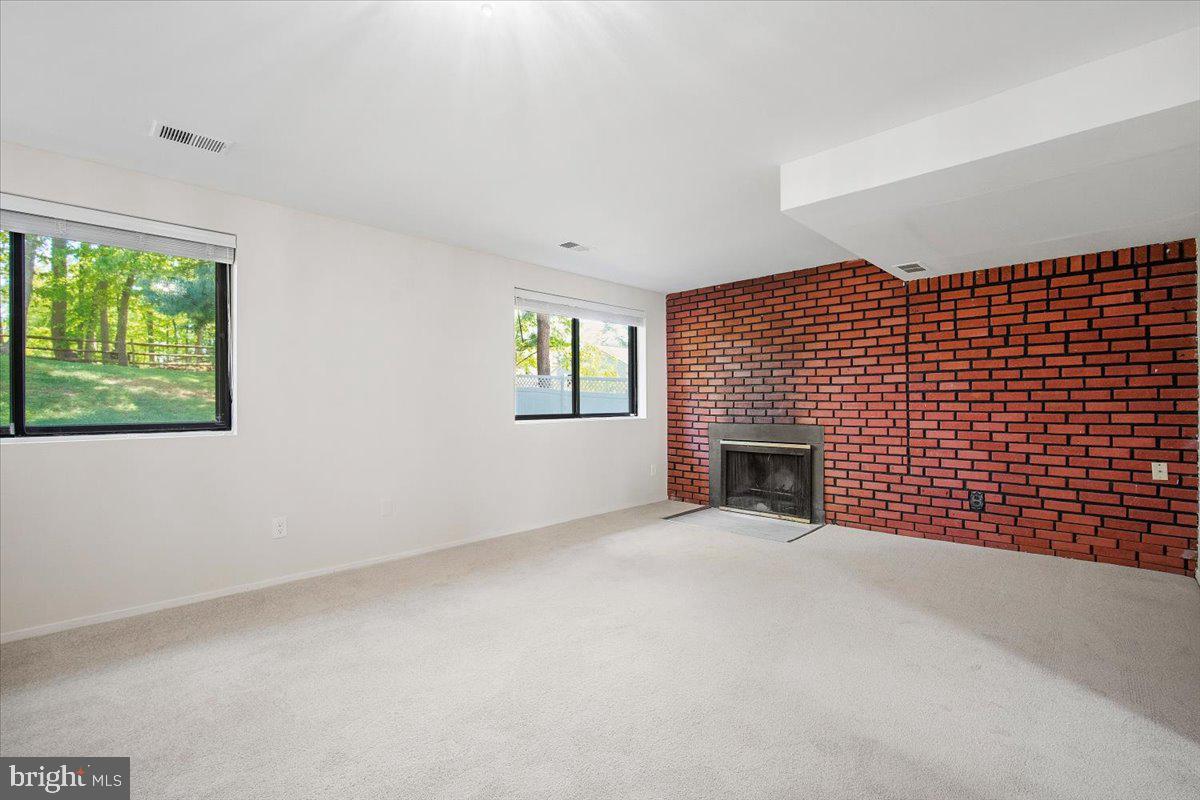 3912 Gelding Lane Olney, MD 20832 - Photo 20 of 62 a view of an empty room with a fireplace and a window