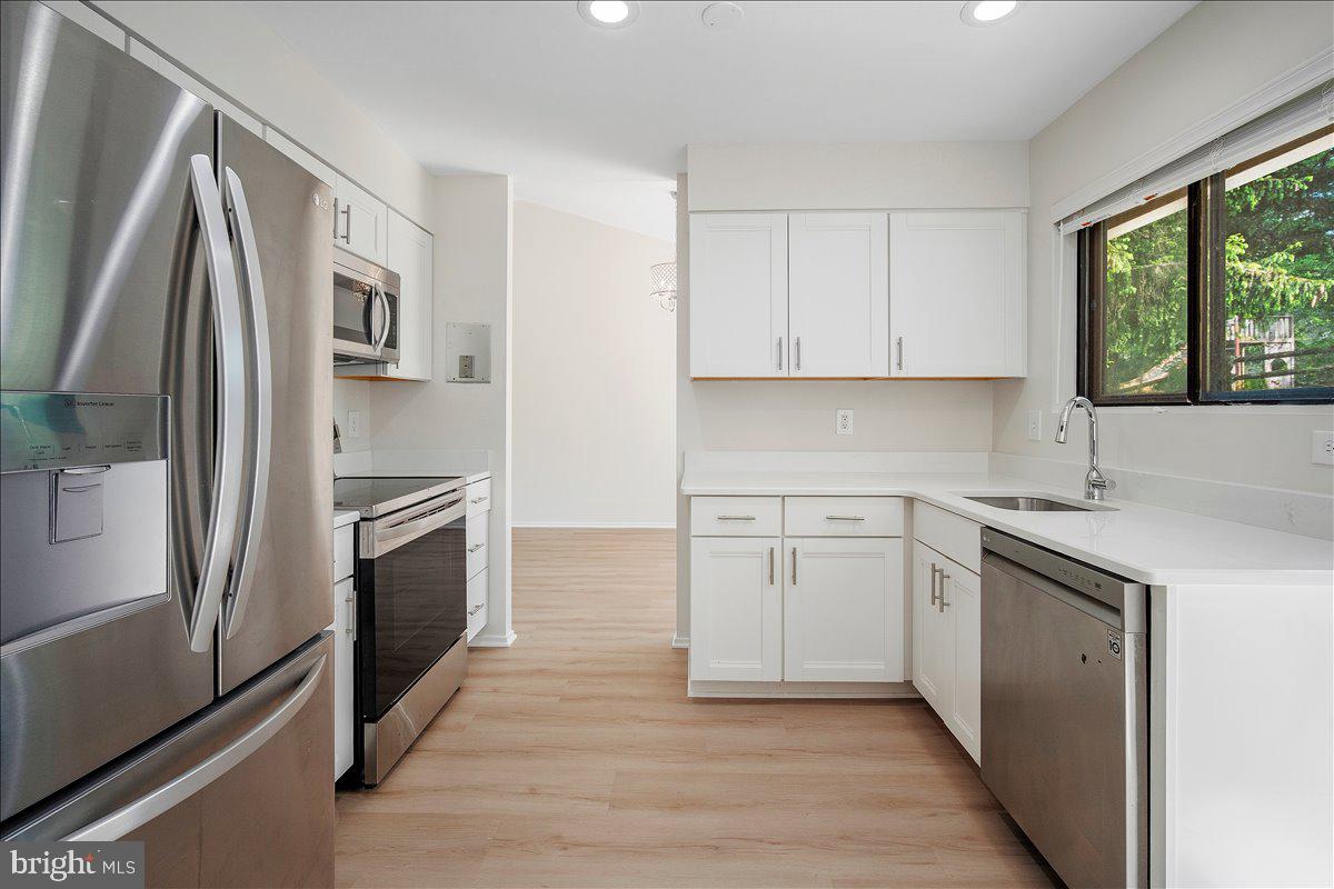 3912 Gelding Lane Olney, MD 20832 - Photo 6 of 62 a kitchen with a refrigerator sink and stove
