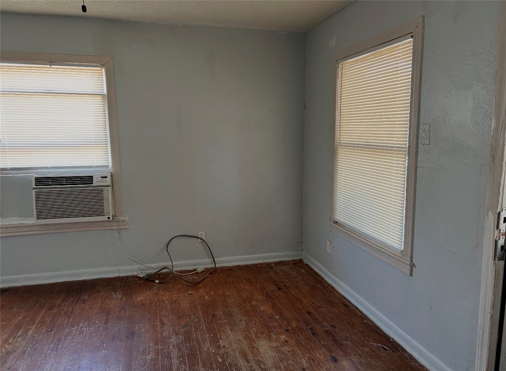 2513 Terrace Street Corpus Christi, TX 78404 - Photo 11 of 24 a view of an empty room with wooden floor and a window