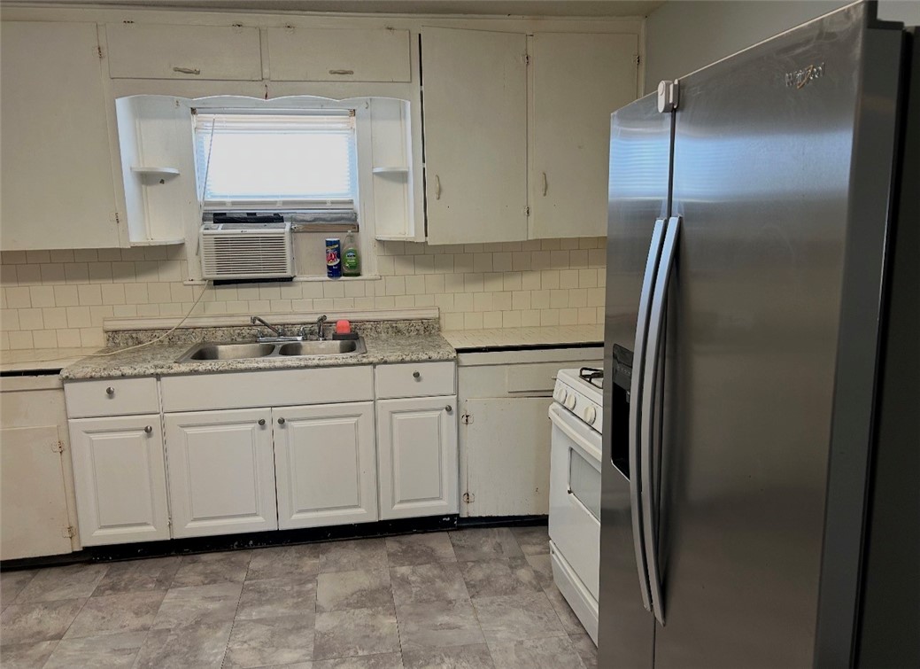 2513 Terrace Street Corpus Christi, TX 78404 - Photo 6 of 24 a kitchen with stainless steel appliances white cabinets and a refrigerator
