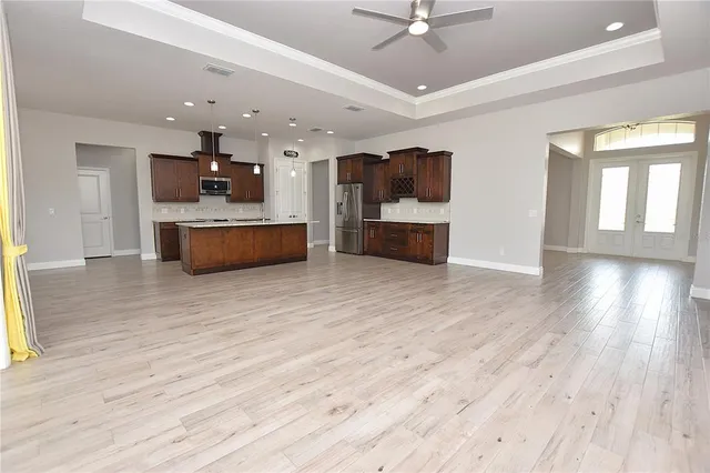 a large room with kitchen view and living room view