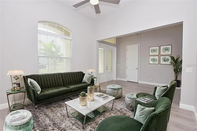 a living room with furniture and a wooden floor