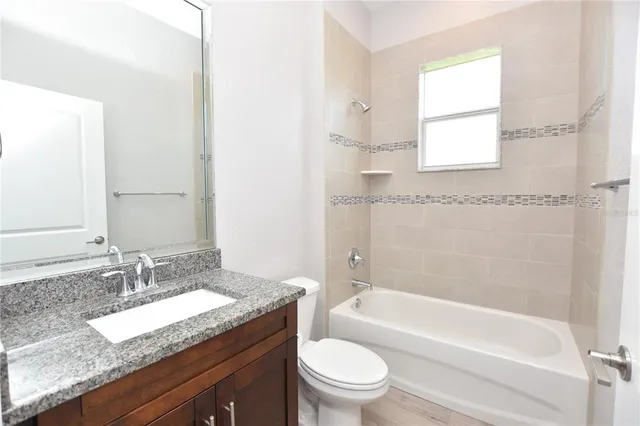 a white toilet sitting next to a bathroom sink