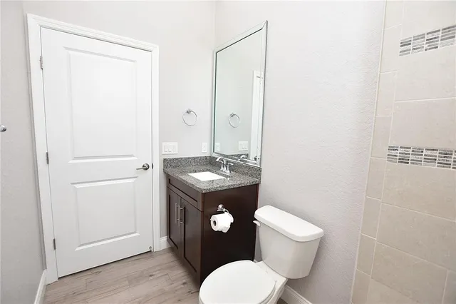 a bedroom with a large bed and a potted plant