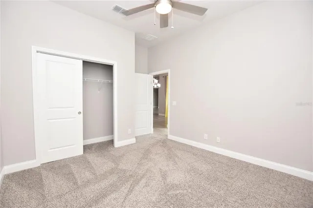 a bathroom with a granite countertop sink a toilet a mirror a bathtub and shower