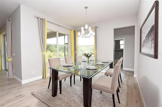 a view of a dining room with furniture and window