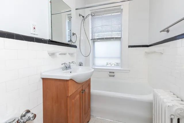 a bathroom with a sink a mirror and a bathtub