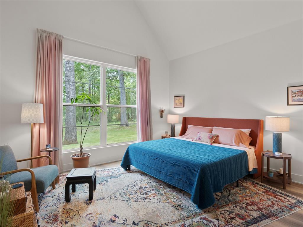 800 John Dean Road Gilmer, TX 75644 - Photo 33 of 40 a bedroom with a bed and large windows