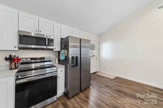 a kitchen with a stove microwave and refrigerator