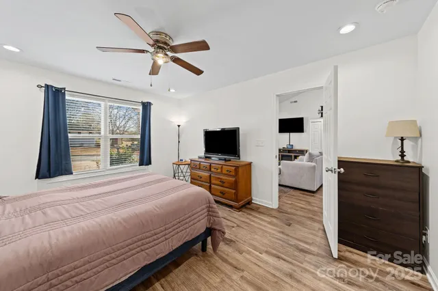 a bedroom with a bed and a television