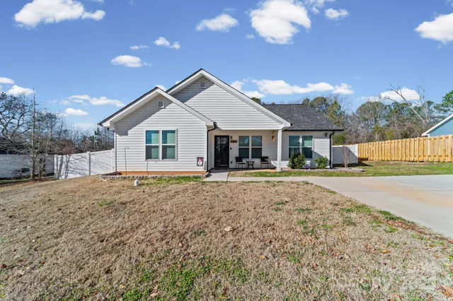a front view of a house with a garden and patio