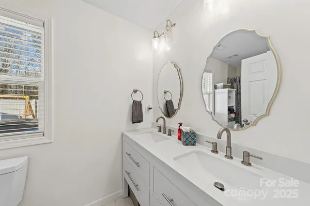 a bathroom with a double vanity sink and a mirror