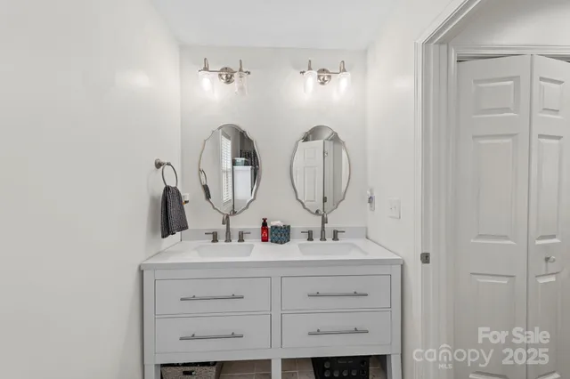 a view of bathroom with mirror and window
