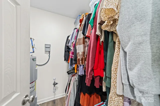 a view of walk in closet with clothes