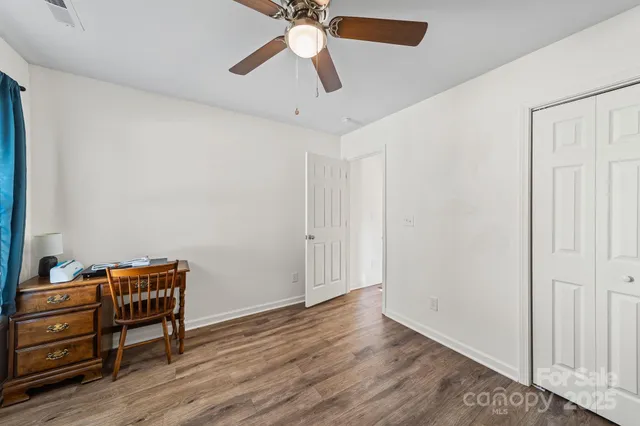 a view of room with wooden floor and closet