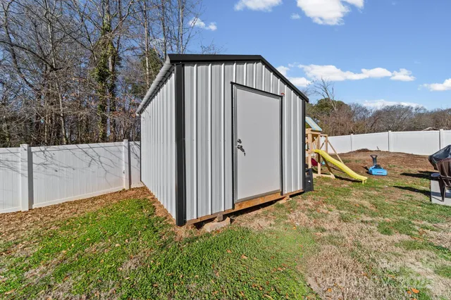a view of backyard with cabin