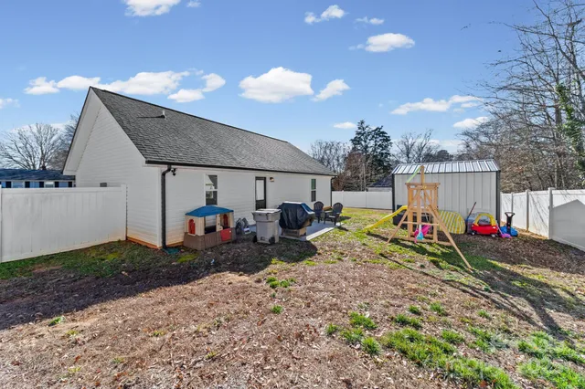 a view of a house with backyard and sitting area