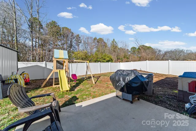 a view of sitting area with furniture and wooden fence