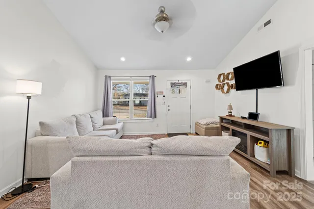 a living room with furniture and a flat screen tv