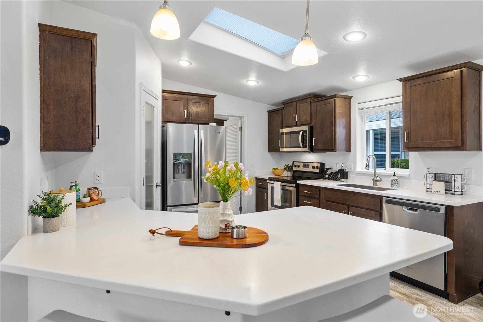 23825 15th Avenue Southeast, Unit 169 Bothell, WA 98021 - Photo 12 of 25 a kitchen with a sink a stove and chairs